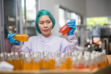 Worker Checking quality or checking stock of glass bottle in beverage factory. Worker QC working in...
