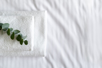 White terry towel on top of comfort bed