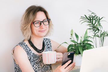 The modern multitasking business woman works with pleasure.