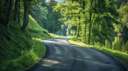 Fototapeta premium A serene riverside road perfect for an afternoon drive, with the sound of water gently flowing nearby.