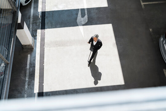 Businessman walking near parking lot at office
