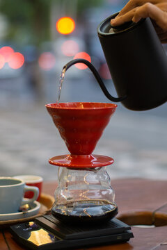 Pouring hot water into v60 filter to make manual brew coffee