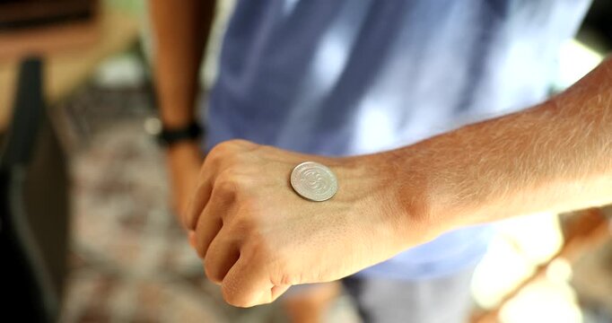 Man flipping silver coin with hand to make right choice closeup 4k movie slow motion. Right decision concept