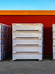 Empty white coffins stacked one on top of other for people donate to corpses without relatives as...