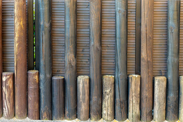 row of wooden posts with some of them being black and some brown