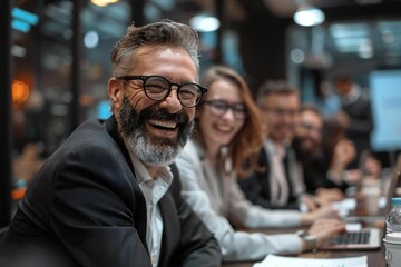 Obraz premium Businesspeople, some wearing eyeglasses, laughing as they sit in office at the presentation, with one well-groomed bearded man among them.