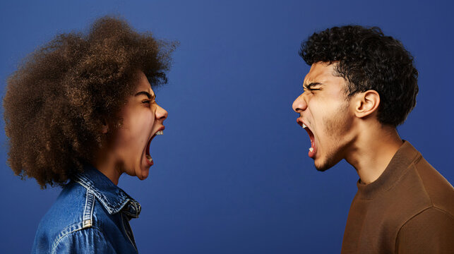 side view of young black man and woman facing each other, both shouting in anger, fighting and yelling