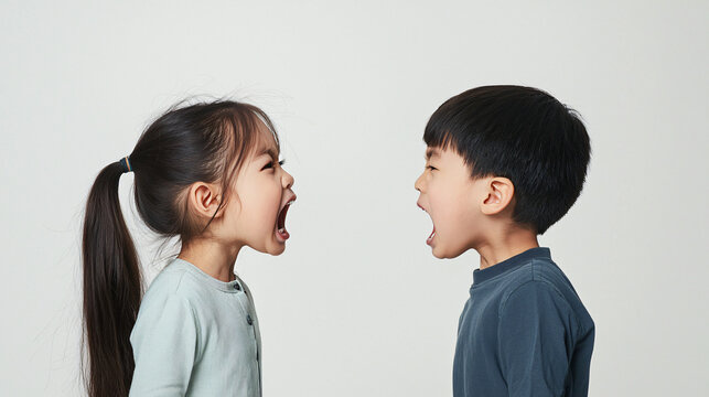 side view of angry asian kids facing each other, both shouting in anger, fighting and yelling
