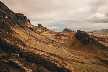 Naklejka premium Scenic view of the Quiraing landslip on the Isle of Skye in Scotland under a cloudy sky