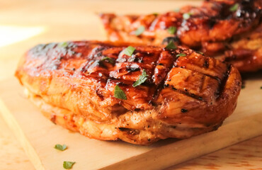 Close-up of grilled chicken breast dish on cutting board