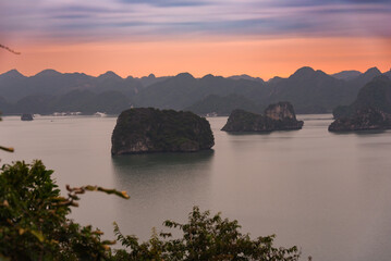 Beautiful landscape of Ha Long bay in Vietnam on sunset, many islands and boats