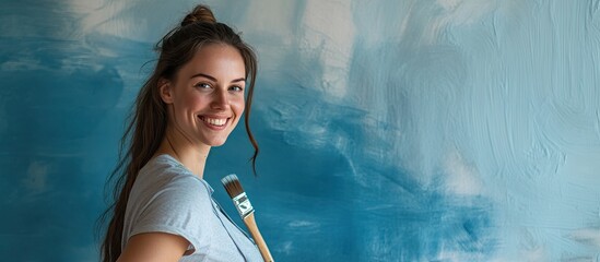 Smiling Caucasian woman is painting the interior wall of her home Renovating the apartment Concept of repair and redecoration Copy space