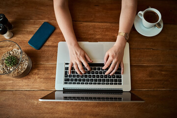 Above, hands and typing on laptop at coffee shop as journalist for headline story or article....