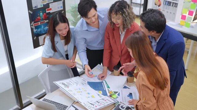Modern office with an Asian business team sharing creative ideas. Collaborative professionals brainstorming strategies in a sleek, innovative environment, promoting teamwork and diversity