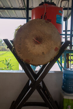 A close up view of a traditional wooden bedug drum at a mosque