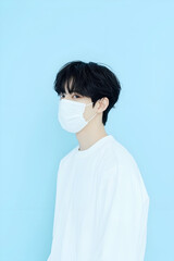 Young Man Wearing a Protective Face Mask for Health Safety in Minimalistic Setting