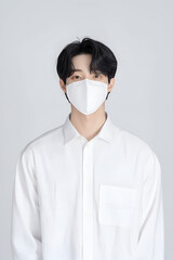 Young Man Wearing a Protective Face Mask for Health Safety in Minimalistic Setting