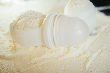 White deodorant antiperspirant on a white background in white powder, talc