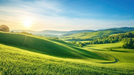 Fototapeta premium Stunning picturesque landscape with rolling hills, a clear blue sky, and lush green fields