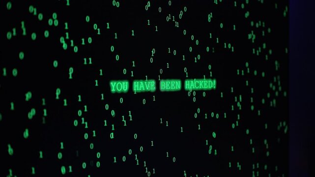 Zoom, Dark Room with Computer Setup, Monitor Showing Green Binary Code and Blinking "You Have Been Hacked!" Message, Emitting a Hacking Vibe.