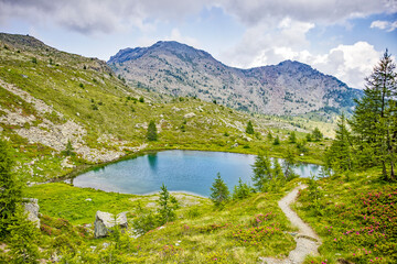 view of a small lake high in the mont avic nature park in the Graian Alps in the aosta valley