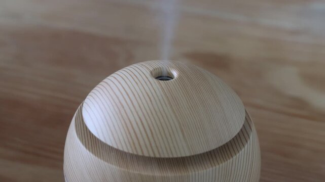 Close up Bamboo diffuser above a wooden table with aromatic 
