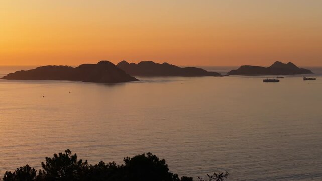 Sunset scenery over the ocean and islands In Nigran, Spain.