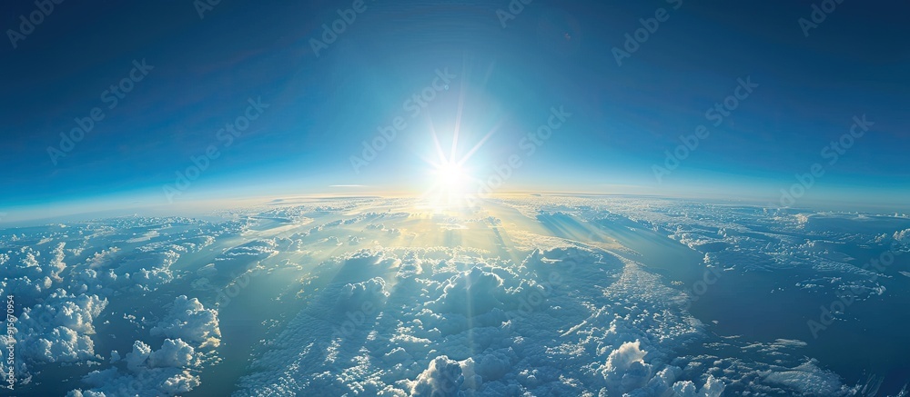 Wall mural Business and travel concept Aerial view from an aircraft cabin window showcasing a stunning blue sky and clouds illuminated by sunlight copy space top view