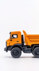 Fototapeta premium Brightly colored plastic toy truck with a large bucket isolated on white