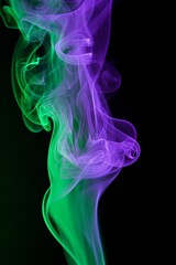 Fototapeta premium Abstract colorful smoke art in purple and green hues on a dark background.