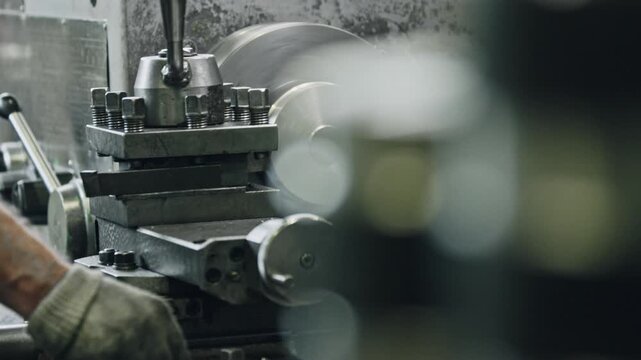 Skilled metalworker shaping metal with precision on a lathe machine in an industrial workshop. Focus on craftsmanship and attention to detail