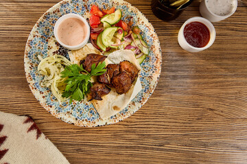 Grilled Shashlik with Fresh Vegetables and Onions on Decorative Plate