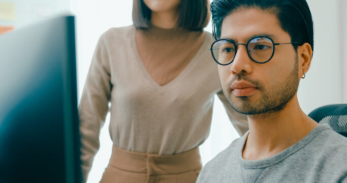 Closeup group Adult Asia male, female freelance meeting write prompt AI bot IT app smart program nomad, video game, talk strategy, discuss plan, user interface, designer, data center desktop computer.