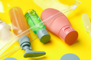 Travel Size Bottles And Containers in a bag On A Yellow Background