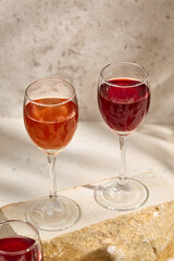 Elegant Composition with Fruit and Berry Liqueurs in Wine Glasses on Rustic Background