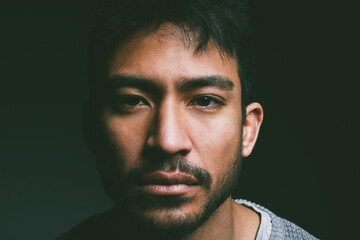 Trauma, portrait and Asian man in studio with depression, crisis or abuse isolated on black...