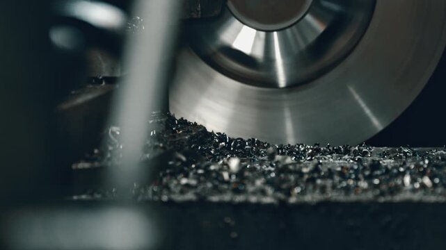 Precision circular saw blade cutting through metal, creating sparks and shavings. Close-up view of industrial machining process showcasing precision and efficiency