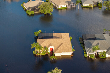 Naklejka premium Flooded residential area with underwater houses and cars from hurricane Debby rainfall water in Laurel Meadows community in Sarasota, Florida. Aftermath of natural disaster in southern USA