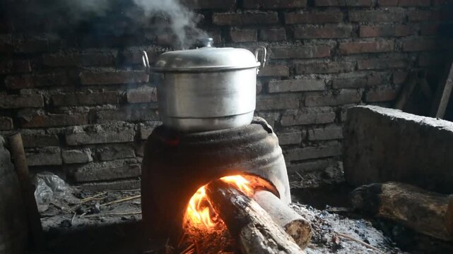 Traditional cooking with a stove made of clay and a hot pot boiling water