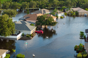 Hurricane Debby tropical rainstorm flooded residential homes and cars in suburban community in...