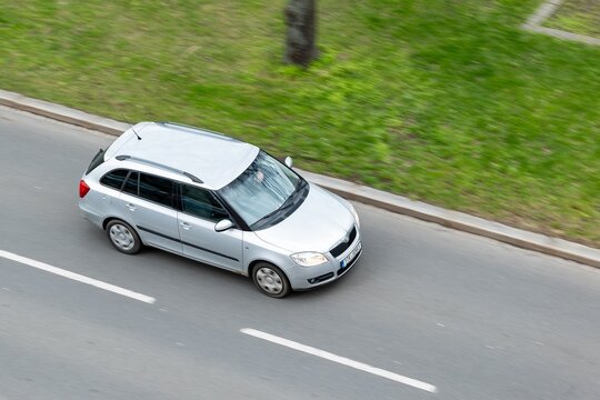 Silver Skoda Fabia II Combi vehicle with motion blur effect in top view