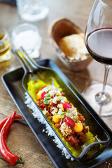 Beef tartare from Black Angus. Egg yolk, pickled cucumber, shallot, pearl onion, coriander and mustard seeds. Delicious healthy Italian food served for lunch in modern gourmet cuisine restaurant