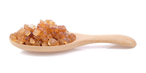 Rock sugar on wooden spoons close up on white background.