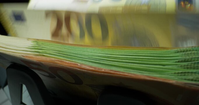 Euro banknotes of different denominations during counting in the counting machine. The currency of the European Union. Close-up