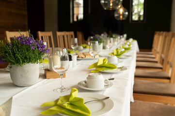 a table set with cups, glasses and dessert plates