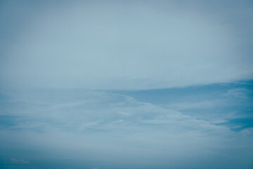 White clouds of different shapes in the blue sky, a miraculous abstract shape, a hot day.