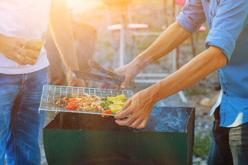Blurred images , A group of colleagues held a barbecue party. (BBQ) inside the villa after work to celebrate success. Barbecue (BBQ) Allows family members and friends to have activities together.