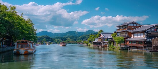 Naklejka premium Scenic River View with Traditional Japanese Houses and Boats