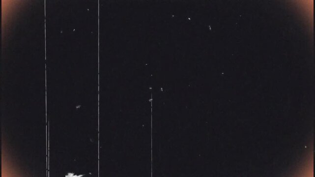 Vintage looping film strip background. 4K reel clutter old tv grain noise frame. Videotape texture overlay with scratches and dirt stains. Lens flare light leaks effect	