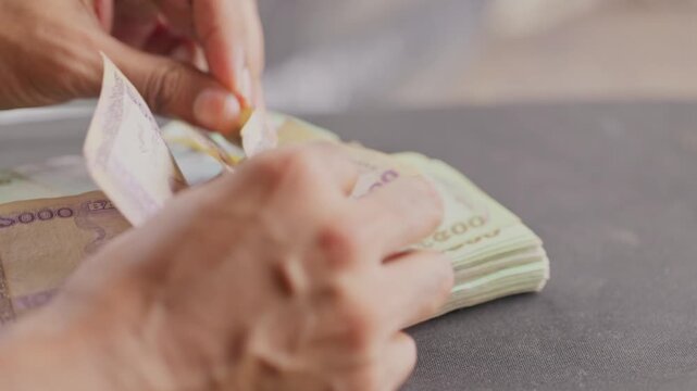 Counting Bangladeshi Taka currency notes. Close up of hand counting Bangladeshi Money. 4K video. New Bangladeshi currency notes